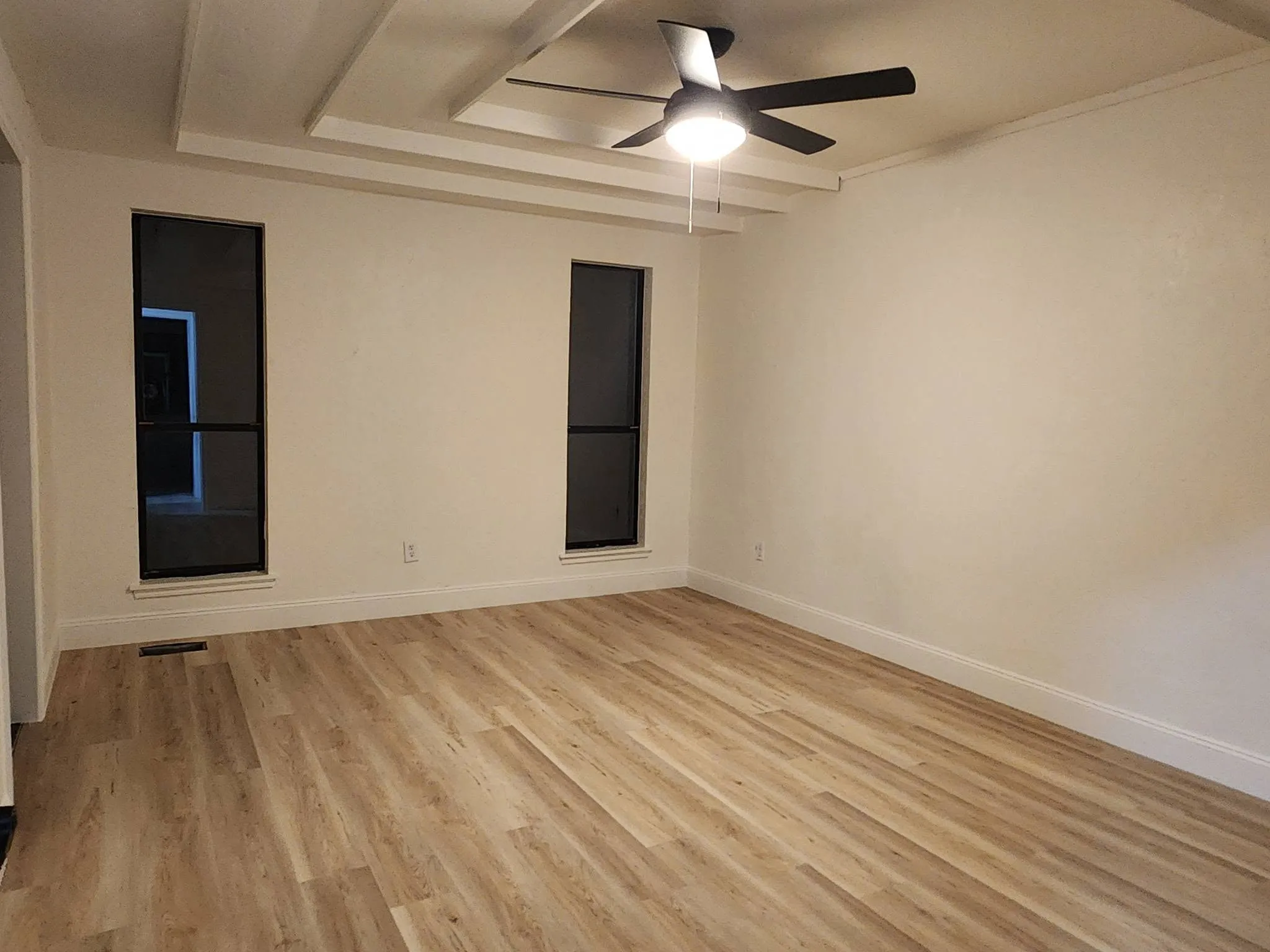 Living room rehab with new LVP floors and coffered ceiling